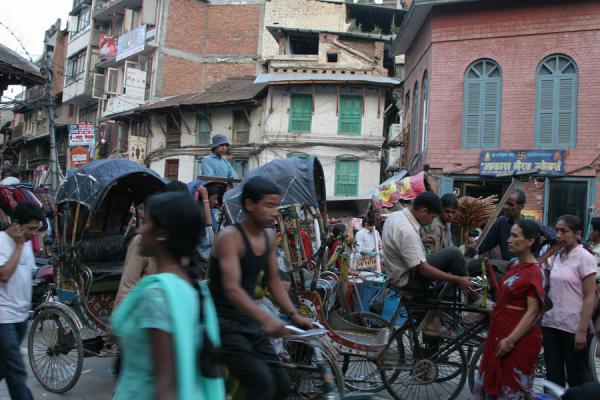 Image of People walking and cycling in one of the many narrow streets of 