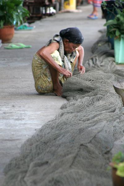 Picture of Ko Panyi (Thailand): Ko Panyi: woman adjusting the nets in one of the streets