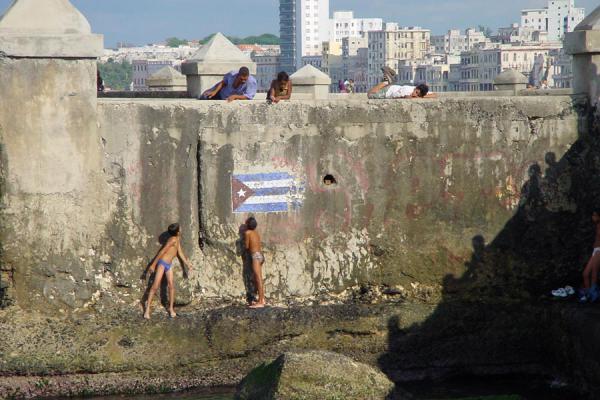 Image of Malecon Habana Habana Cuba Small boys playing at Malec n