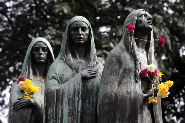Image of Statues of three women with flowers at San Pedro Cemetery 