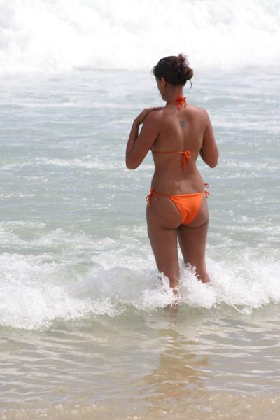 Image of Rio girl adjusting her bikini Rio de Janeiro Brazil
