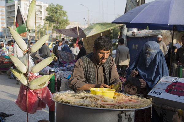 Picture of Selling roasted corn to a woman in the bazaarMazar-e-Sharif - Afghanistan