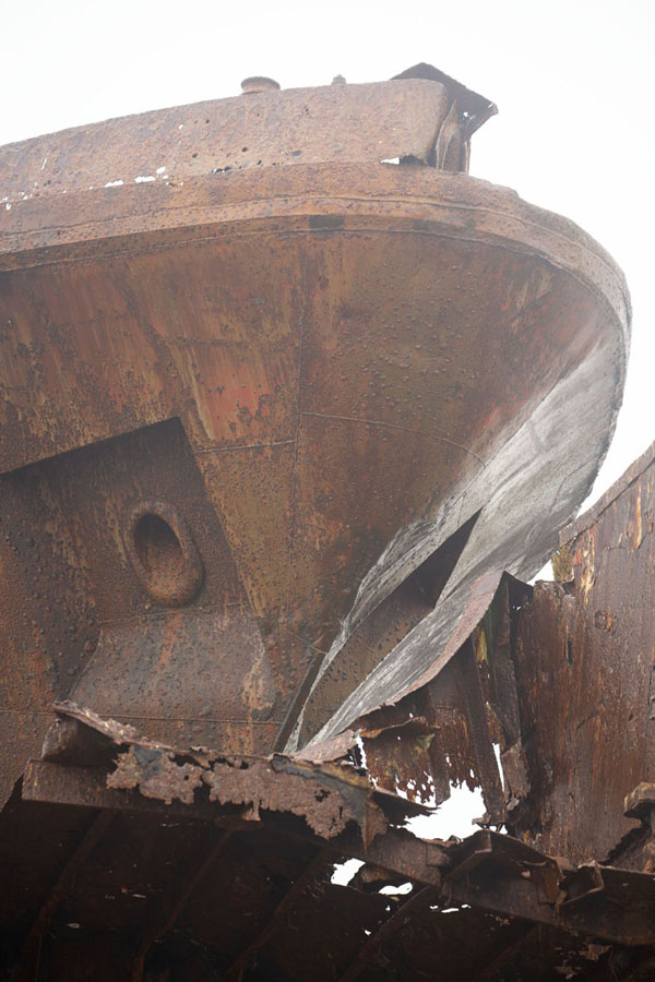 Close-up of rusted huill of a ship resting on another wreck | Scheepswrakken strand | Angola