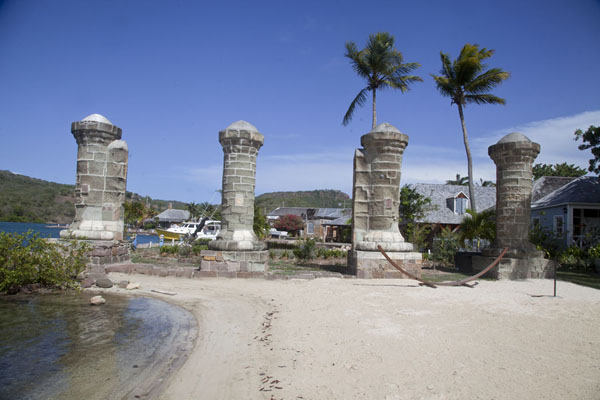 Picture of English Harbour (Antigua and Barbuda): Boat House Pillars and a small beach in Nelson's Dockyard