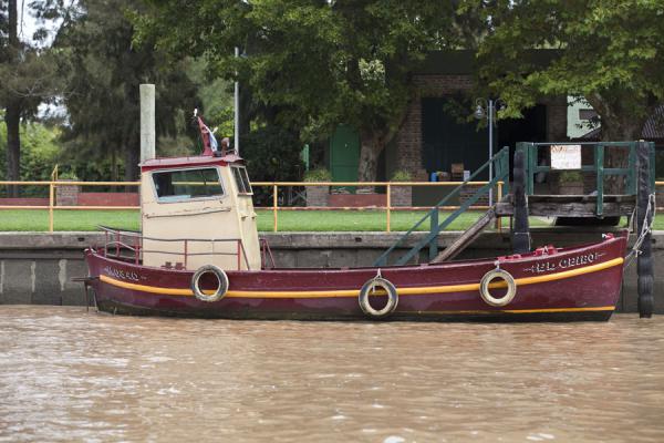 Small boat docked at a bank of a main river in the Paraná delta | Tigre Paraná Delta | Argentina
