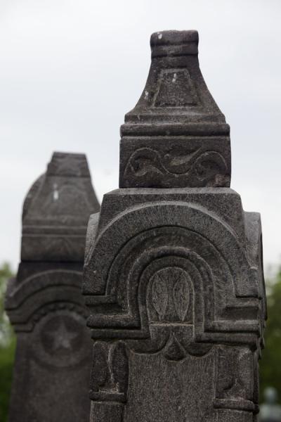 Picture of Odzun church (Armenia): Tombstones can be found scattered all around the grounds of Odzun church