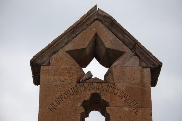 Detail of modern monument in front of Odzun with star, and hammer and sickle symbol on the side | Odzun church | Armenia