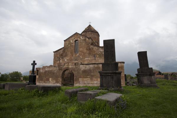 Tombstones of clergy with Odzun church in the background | Odzun church | Armenia