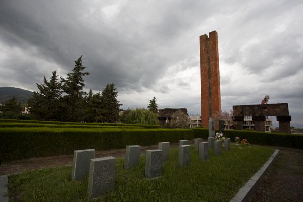 Rows of graves and the red obelisk marking the centre of the Stepanakert memorial complex | Complesso commemorativo di Stepanakert | Armenia