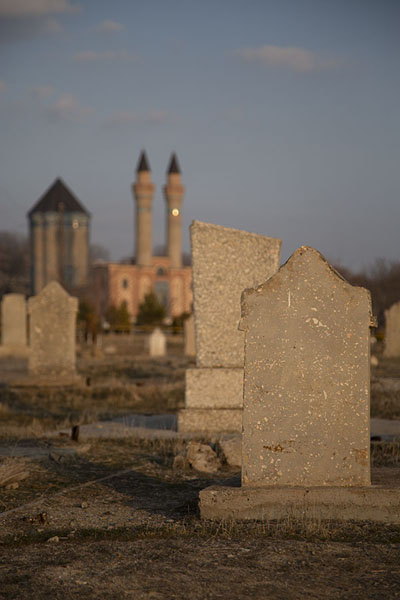 Picture of The mausoleum is visible behind these tombstones in a nearby graveyard
