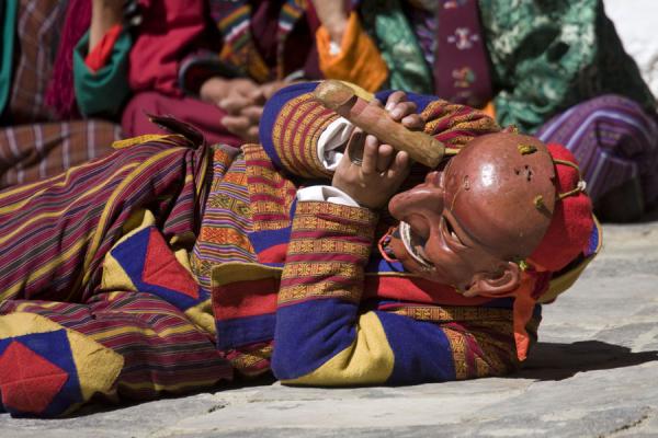 Picture of Atsara with wooden phallus having fun and entertaining the crowdJakar - Bhutan