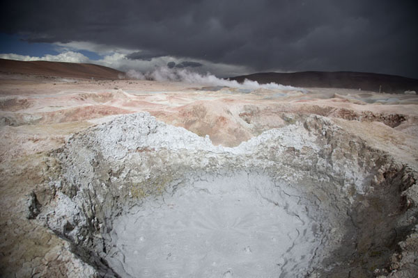 Picture of Sol de Mañana geysers (Bolivia): Boiling mud in a crater under a dark sky at Sol de Mañana