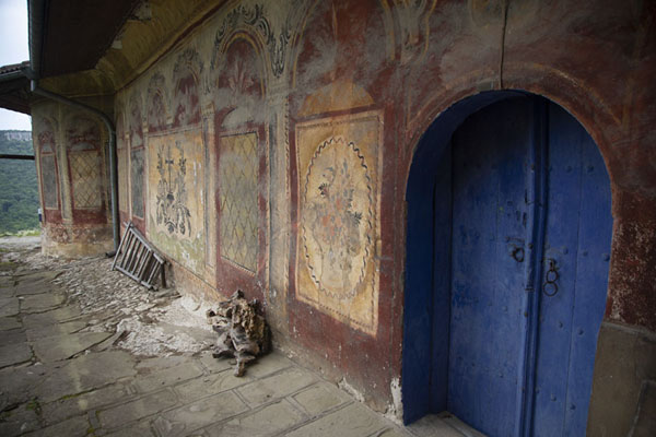 The side wall of the church with a blue door | Transfiguration monastery | Bulgaria