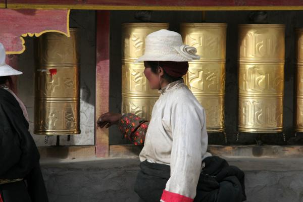 Picture of Gyanak Mani (China): Keep the wheels spinning: a Tibetan woman on her kora around Gyanak Mani