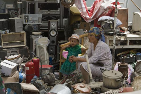 Picture of Old TV sets and Uyghur woman and child in Hotan bazaar