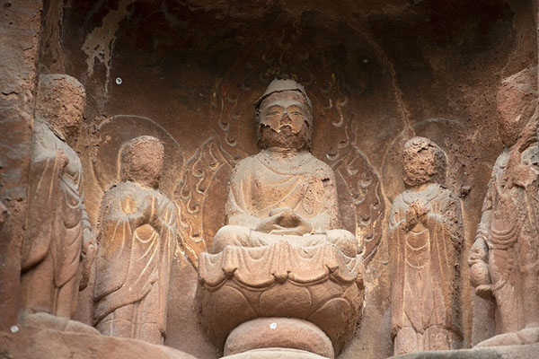 Seated Buddha figure on a lotus flower sculpted out of the cliff rock | Cliff of Thousand Buddhas | China