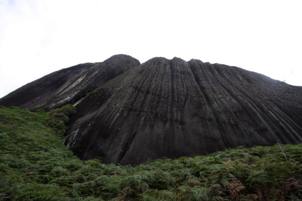 The enormous rock formation of Peñón seen from below | El Peñón de Guatapé | Colombia