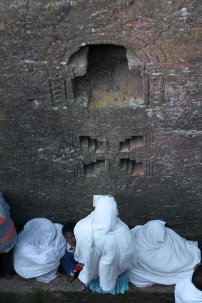 Picture of Lalibela Sunday Mass (Ethiopia): Women praying against the wall of Bet Mikael