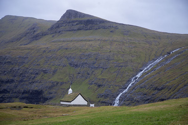 White church at Saksun with big waterfall coming down the mountain | Saksun Tjørnuvik Hike | 