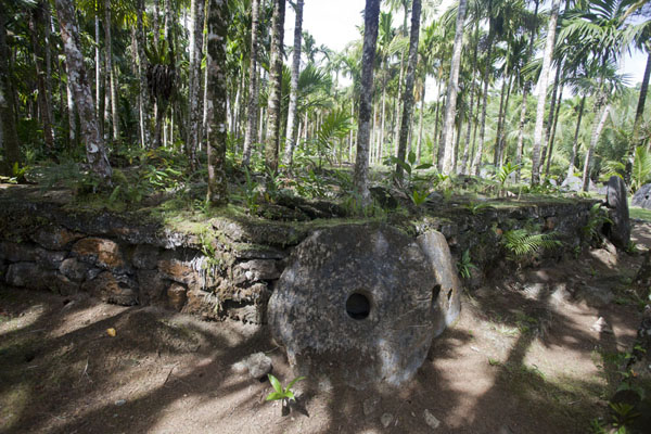 Stone money resting against the platform at Gilman | Gilman stone money bank | Federated States of Micronesia