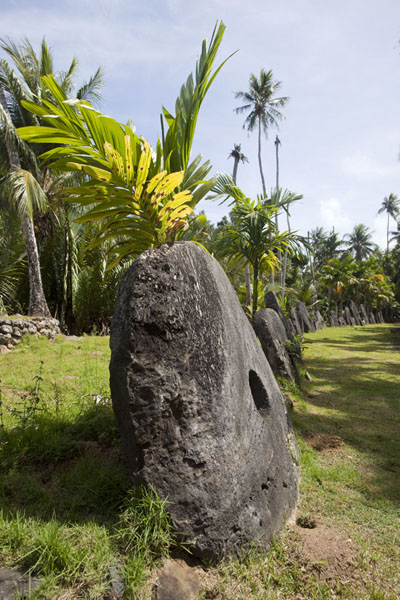 Side view of row of stone money disks at Gilman | Gilman stone money bank | Federated States of Micronesia