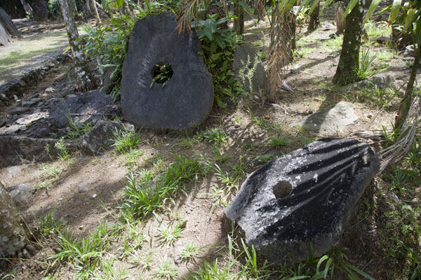 Some stone money disks scattered around the ground of Gilman stone money bank | Gilman stone money bank | Federated States of Micronesia