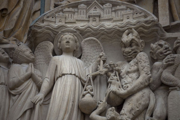 Picture of Detail of the Portal of Last Judgment: souls are led to heaven (left) or hell (right)Paris - France