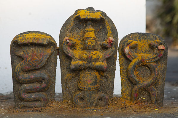 Sculpted cobras and praying man on stele | Bull Temple | India