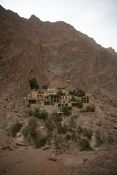 Buildings and trees clinging to the rock face at Chak Chak | Chak Chak | Iran