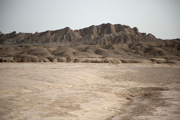 Dark mountains and flat land in Lut Desert | Lut Desert | Iran