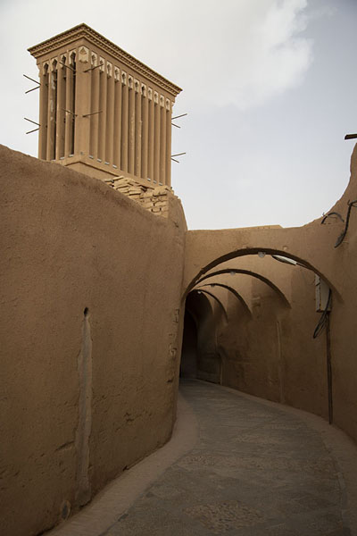 Picture of One of the many wind towers above a street with archesYazd - Iran