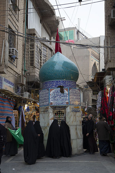 Women at a small shrine in the streets of Karbala | Karbala holy shrines | Iraq