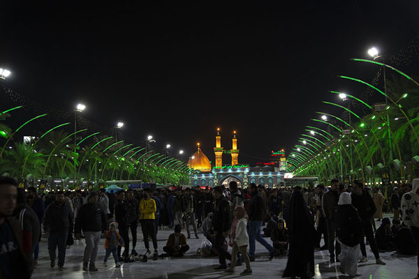 Looking towards the gilded towers and dome of Al-Abbas across the rectangular square | Karbala holy shrines | Iraq