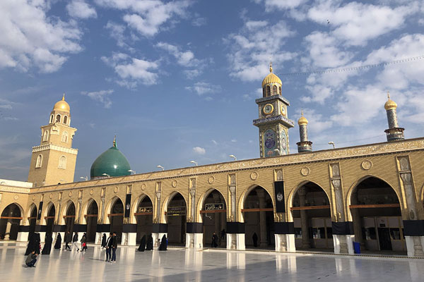 View from the central courtyard of the Great Mosque of Kuga with clock tower and minarets | Great Mosque of Kufa | Iraq