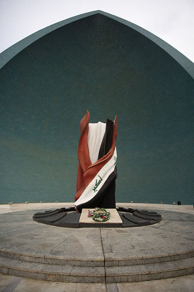 Picture of Iraqi flag with one of the semi-spheres in the backgroundBaghdad - Iraq