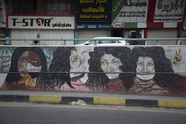 Four women wearing Iraqi-flag masks on a mural | Tahrir Square Tunnel Murals | Iraq
