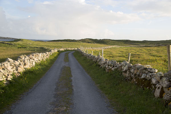 Picture of Stone walls at both sides of a narrow road on Omey Island
