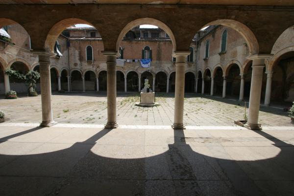 Arches and courtyard of the San Pietro di Castello church | Castello | Italy