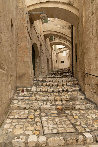 Cobblestone street spanned by arches | Matera | Italy