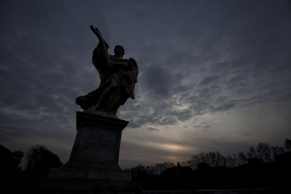 Picture of Ponte Sant'Angelo (Italy): Sun rising above a statue on the Ponte Sant'Angelo
