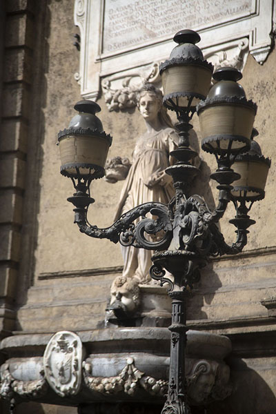 Picture of Street lantern with statue behindPalermo - Italy