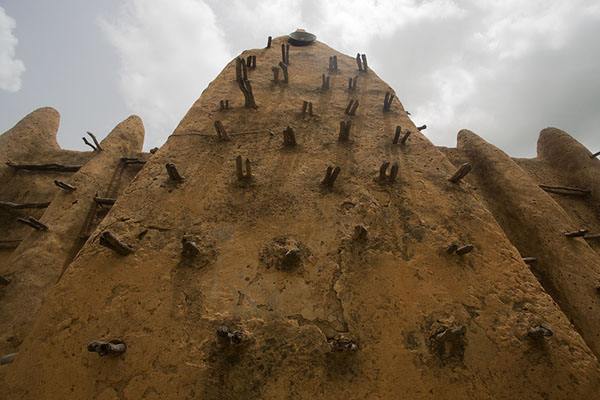 Picture of Looking up the centuries-old walls of Sorobango mosque with wooden beams sticking outSorobango - Ivory Coast