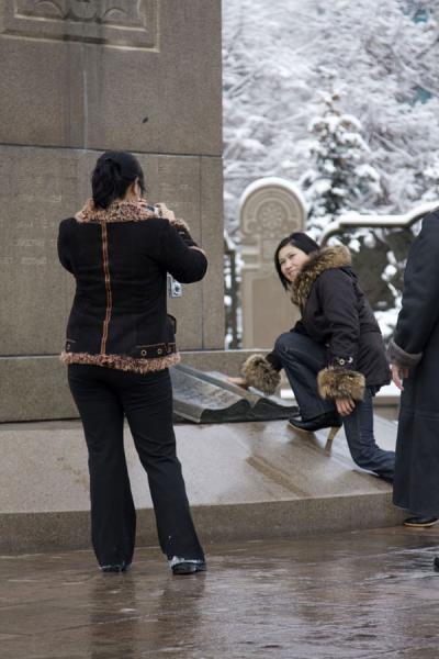 Picture of Independence Monument (Kazakhstan): Kazakh women posing with the bronze book representing the constitution