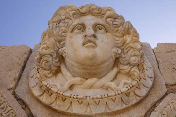 Looking up a medusa head on a lintel in the Severan Forum of Leptis Magna | Leptis Magna | Libia
