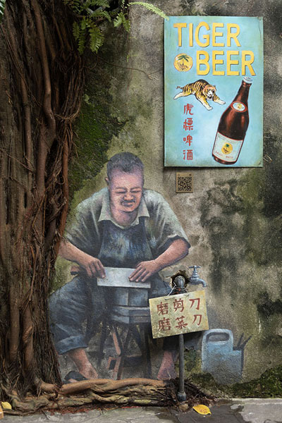 Picture of Guy sitting under a tree, wall painting in Kwai Chai HongKuala Lumpur - Malaysia