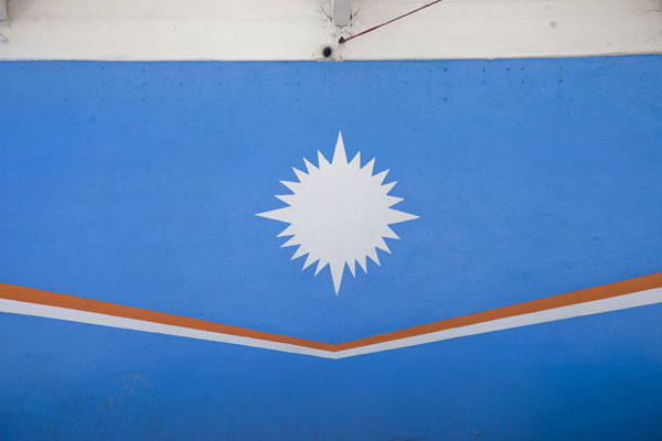 Picture of The Marshallese flag painted on a bigger traditional canoeDelap - Marshall Islands