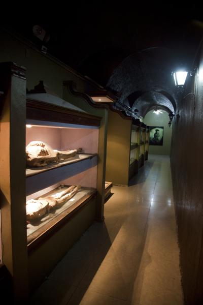One of the dark corridors with mummies lying on display | Mummies Museum | Messico