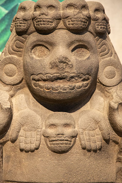 Close-up of sculpture with skulls around the head | National Museum of Anthropology | Mexico