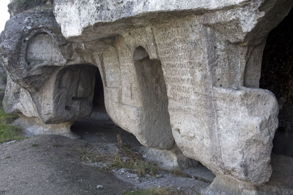 Some of the openings of Bosie monastery covered by texts carved out of the rock surface | Monastère de Bosie | Moldavie