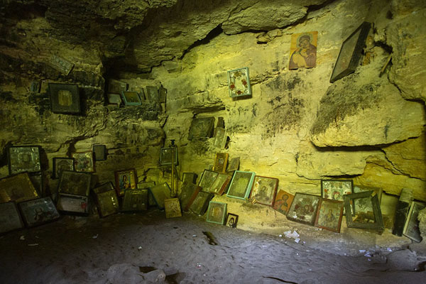 Picture of Shrine inside a cave with many religious images against the rocky wall - Moldova - Europe
